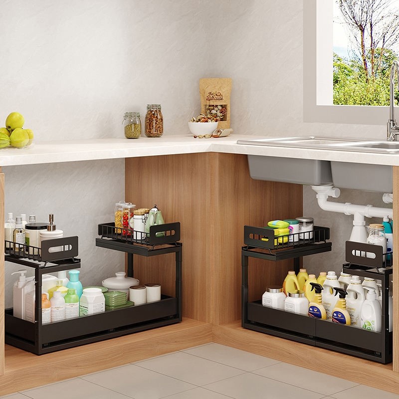 Two-tier pull-out under-sink organizer with cleaning supplies in a cabinet